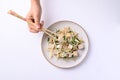 Stir fried tofu with mung bean sprouts eating by using chopsticks Royalty Free Stock Photo