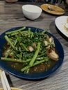 Stir-fried Morning Glory with Crispy Pork (Pad Pak Boong Moo Krob) Royalty Free Stock Photo