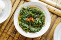 Stir-fried Water Spinach, Morning Glory, Stir-fried Kale, tumis kangkung served on a white plate