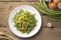 Stir fried Yardlong bean with eggs in white plate. Royalty Free Stock Photo