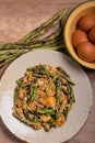 Stir fried Yardlong bean with eggs on wooden background Royalty Free Stock Photo