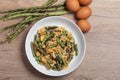 Stir fried Yardlong bean with eggs on wooden background Royalty Free Stock Photo