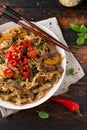 Stir fry Beef Chow Fun with rice noodles, bean sprouts, spring onions and chili.