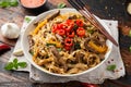 Stir fry Beef Chow Fun with rice noodles, bean sprouts, spring onions and chili.