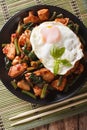 Stir-Fry Chicken with basil, green beans and a fried egg on a pl