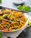 Stir fry noodles with beef and vegetable in white bowl. asian style food