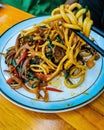 Stir fry noodles with beef and vegetable in white bowl. asian style food