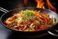 Stir fry noodles with beef and vegetables in wok on fire, Indulge in the fiery excitement of Asian street food with a sizzling wok Royalty Free Stock Photo