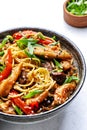 Stir fry noodles with chicken slices, red paprika, mushrooms, chives, soy sauce and sesame seeds in ceramic bowl. Asian cuisine Royalty Free Stock Photo