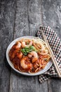 Stir fry noodles with shrimps and vegetables on wooden table Royalty Free Stock Photo