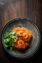 Stir fry noodles with vegetables and shrimps in plate on wooden table Royalty Free Stock Photo