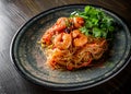 Stir fry noodles with vegetables and shrimps in plate on wooden table Royalty Free Stock Photo
