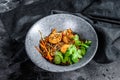 Stir fry Rice noodles with shrimps and vegetables. Asia wok. Black background. Top view