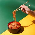 Stir fry soba noodles with beef and vegetables in wok on dark background, Asian udon noodles with beef WOK in black bowl Royalty Free Stock Photo