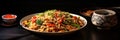 Stir fry yakisoba noodles with vegetables, soy sauce, chicken on white plate on black background. Amazing japanese food