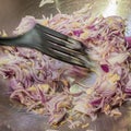 Stir-frying chopped onions, shallots and garlic in a wok.