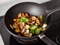 Stir-frying Ginger and clams at high heat to bring forth the savory aroma with sesame oil