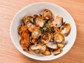 Stir-frying Ginger and clams at high heat to bring forth the savory aroma with sesame oil