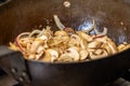 Stir Frying Mushrooms and Onions in a Wok