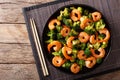 Stir frying shrimp with broccoli closeup. Horizontal top view