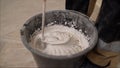 Mixing concrete plaster with electric mixer. Stir the solution in a bucket Royalty Free Stock Photo