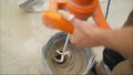 Mixing concrete plaster with electric mixer. Stir the solution in a bucket Royalty Free Stock Photo