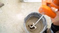 Mixing concrete plaster with electric mixer. Stir the solution in a bucket Royalty Free Stock Photo