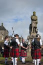 Band of pipers playing in front of the statue of Robert the Bruce in the Stirling Castle in Sirling, Scotland