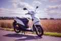 Stirling, Scotland - 15 August 2019: Honda moped with meadow in the background