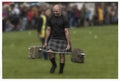 Strongman carrying weights at the Stirling Higland Games