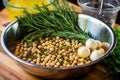 stirring a bowl full of chickpeas, garlic, and herbs before roasting Royalty Free Stock Photo