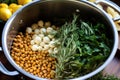 stirring a bowl full of chickpeas, garlic, and herbs before roasting Royalty Free Stock Photo