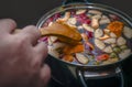 Stirring Colorful Apple Slices, Oranges, Fruit Mix In A Pot With Wooden Spoon. Healthy Eating Habits. Refreshing Fruit Apple Cider