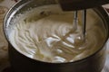 Stirring the dough with a mixer in a saucepan Royalty Free Stock Photo