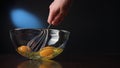 Stirring Eggs in a Glass Bowl with a Whisker