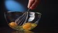 Stirring Eggs in a Glass Bowl with a Whisker