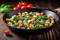 stirring gnocchi, spinach, and sausage in skillet Royalty Free Stock Photo