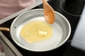 Stirring melted butter on frying pan in kitchen