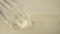 Stirring melted liquid White chocolate with steel whisk Royalty Free Stock Photo