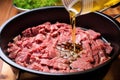 stirring sliced beef in teriyaki marinade