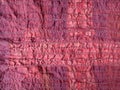 Stitched back side of crinkled red silk scarf Royalty Free Stock Photo