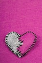 Stitched broken felt heart on a on pink background Royalty Free Stock Photo