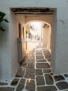 Stoa with shelter and arch over at Naousa village, Paros island, Greece. Vertical Royalty Free Stock Photo