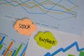 Stock and Buyback write on sticky notes isolated on Wooden Table Royalty Free Stock Photo