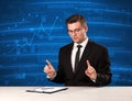 Stock data analyst in studio giving adivce on blue chart background Royalty Free Stock Photo