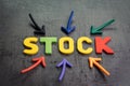 Stock or equity market, investment asset concept, arrows pointing to the center with colorful letters building the word STOCK