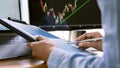 Stock exchange trader working with graphs,diagrams on monitor in modern trading office