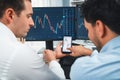 Stock exchange traders pointing lowest chart stage on dynamic graph. Sellable.