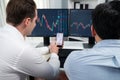 Stock exchange traders pointing lowest chart stage on dynamic graph. Sellable.