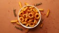 A white bowl filled with seasoned curly fries is placed on a brown surface Royalty Free Stock Photo